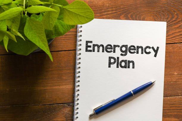 istock EMERGENCY PLAN text written in an office notebook on a wooden table. 1250248540