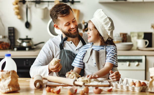 istock Father and daughter making pastry together 1250248710