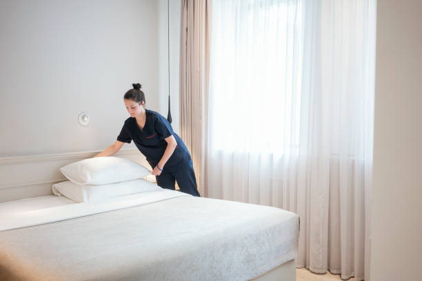 istock Maid doing the bed, preparing hotel room for guests 1250250097
