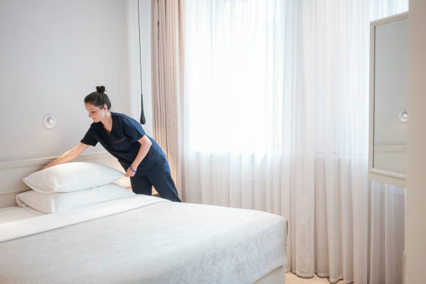 istock Maid doing the bed, preparing hotel room for guests 1250250107