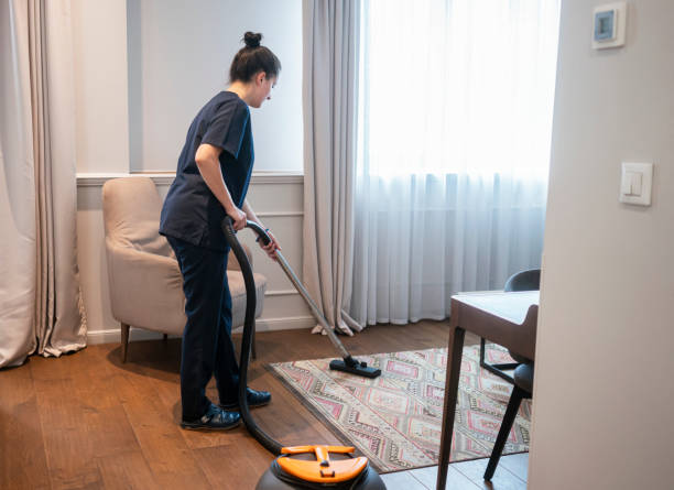 istock Maid vacuuming hotel room 1250250139