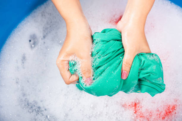 istock Female squeeze wring out wet fabric cloth 1250255193