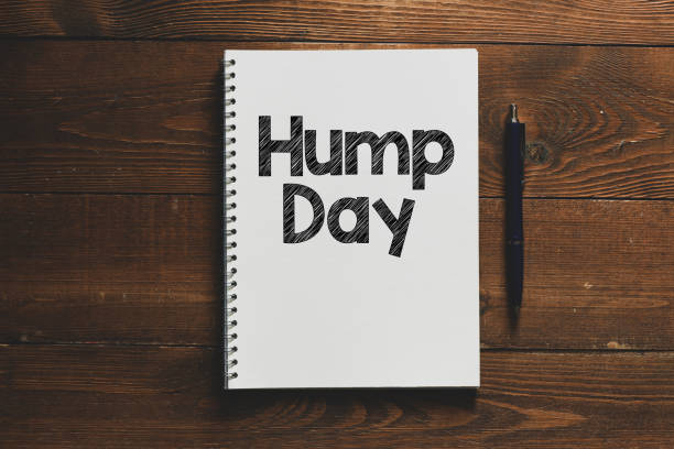 istock HUMP DAY text written in an office notebook on a wooden table. 1250255765