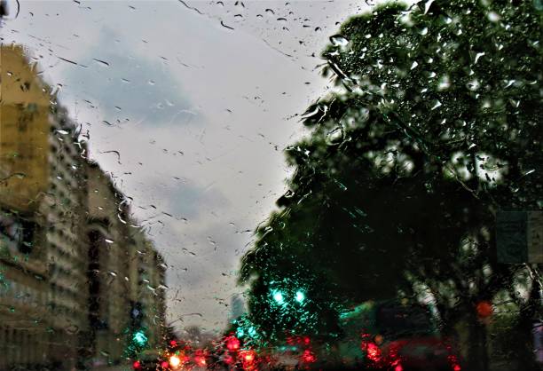 Rainy city street. View through the window on rainy day. stock photo