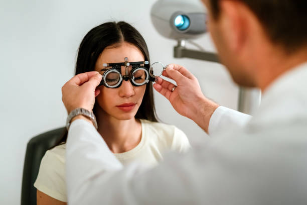 istock Optician with trial frame and patient at clinic 1250260443