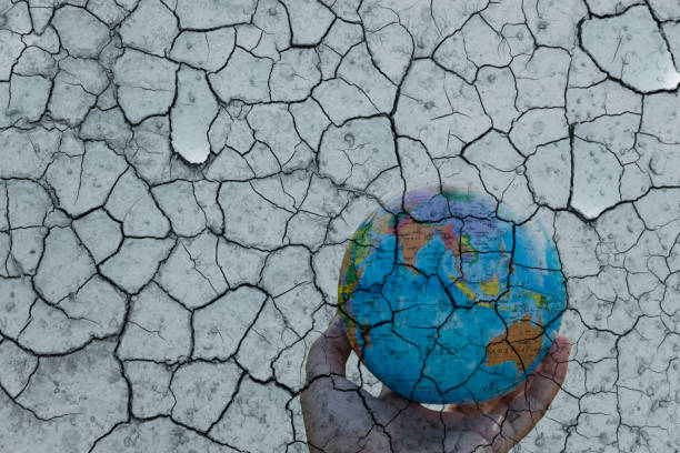istock blue earth model on human hand with soil crack in environmental crisis concept 1250260843