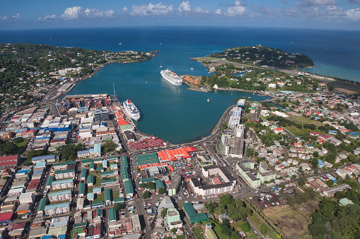 Castries, St Lucia Island, The Caribbean, December 15 2017, aerial view of streets, buildings and two cruise ships docked with airport at top right of picture