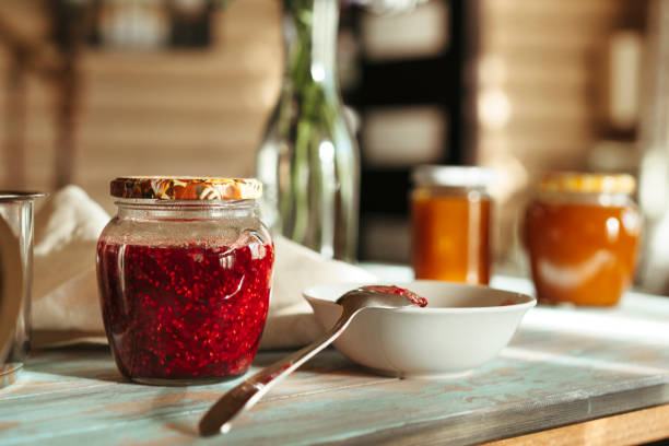 istock Homemade raspberry jam in a glass jar. 1250261196