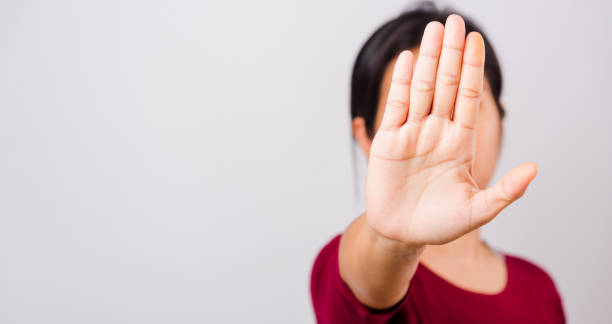 istock Asian beautiful woman itching her outstretched hand showing stop gesture front face, focus 1250262445