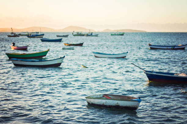 Line up of boats at sunset in Buzios, Brazil Line up of boats at sunset in Buzios, Brazil in Armação dos Búzios, RJ, Brazil shades of blue stock pictures, royalty-free photos & images