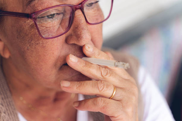 close-up of old woman smoking a cigarette Smoking - Activity, Smoke - Physical Structure, One Woman Only, Cigarette, Senior Women smokers wrinkles stock pictures, royalty-free photos & images
