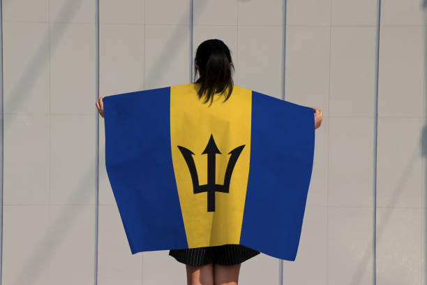 istock Woman is holding Barbados flag on her shoulder. 1250265214