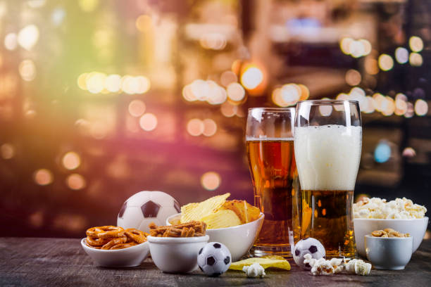 International beer day background International beer day. Glasses with light beer and salty snacks on a bar counter international match stock pictures, royalty-free photos & images