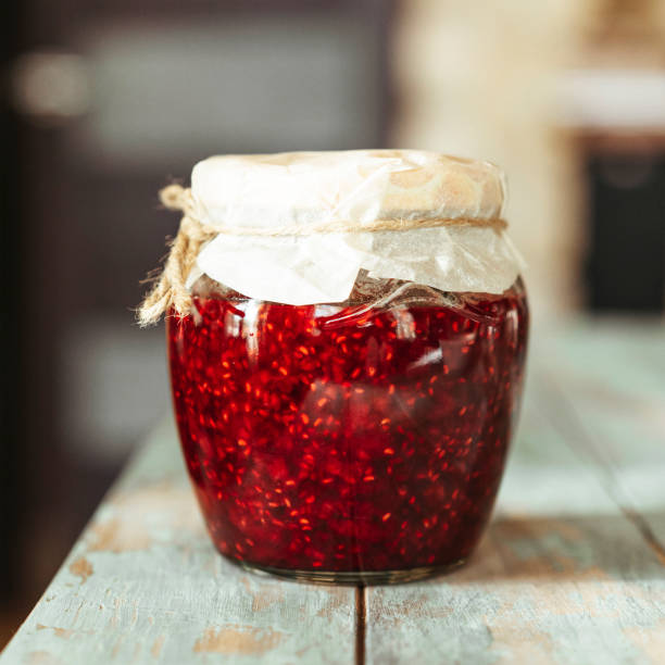 istock Homemade raspberry jam in a glass jar. 1250265366