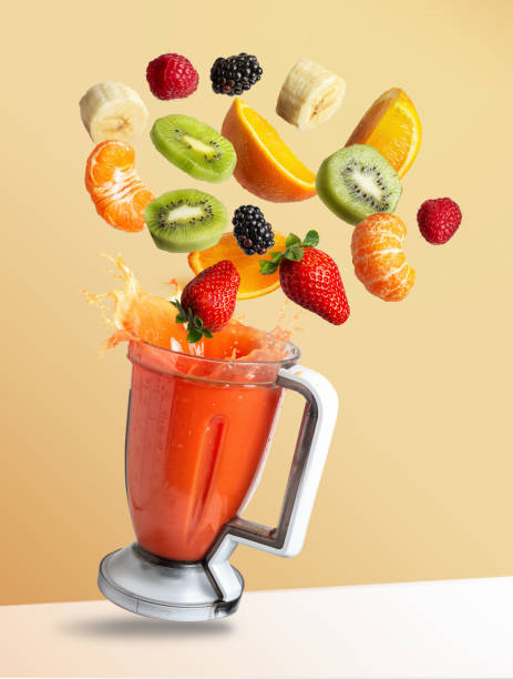 istock Fruits flying in a blender with fruit juice, isolated from the orange background 1250266332