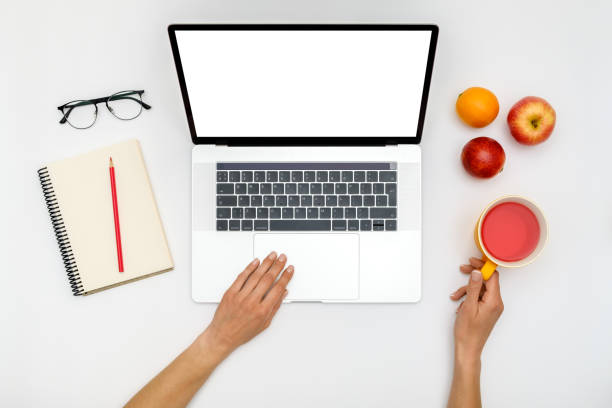 istock Top view of beautiful woman 's hands using laptop placed on white desktop. Flat lay 1250267749