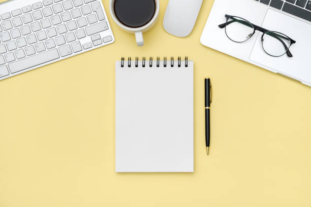 istock Minimal workplace with laptop and blank notepad on colored background. Top view. Flat lay 1250267777