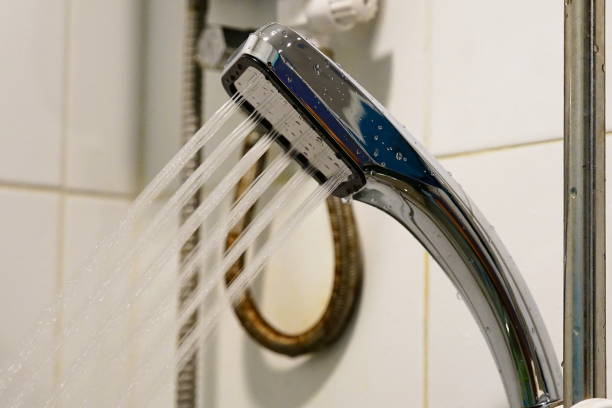 istock Shower head sprinkling water 1250269057