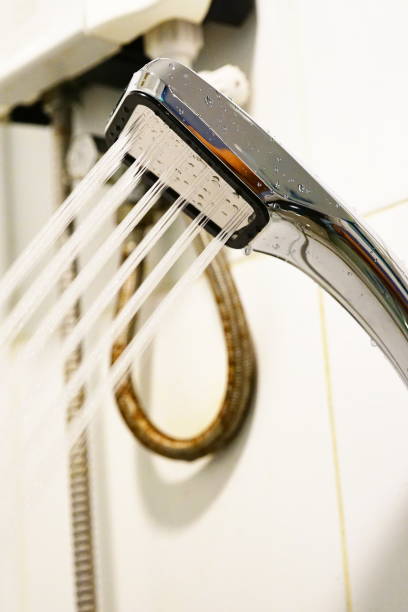 istock Shower head sprinkling water 1250269075