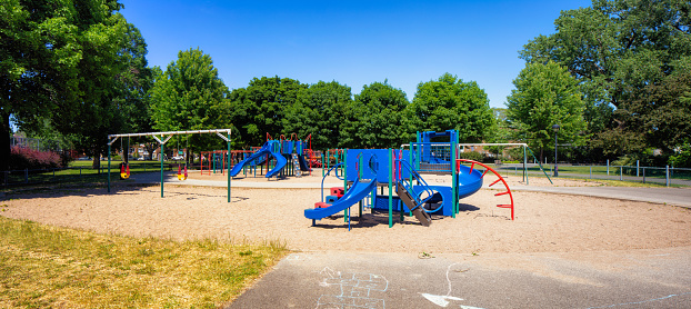 Panoramic view of a Children's playground in Montreal's Rosemont area on a clear sunny late Springtime day.