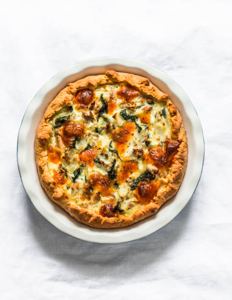 istock Tuna, mozzarella cheese, spinach, potatoes rustic simple pie on a light background, top view 1250270821