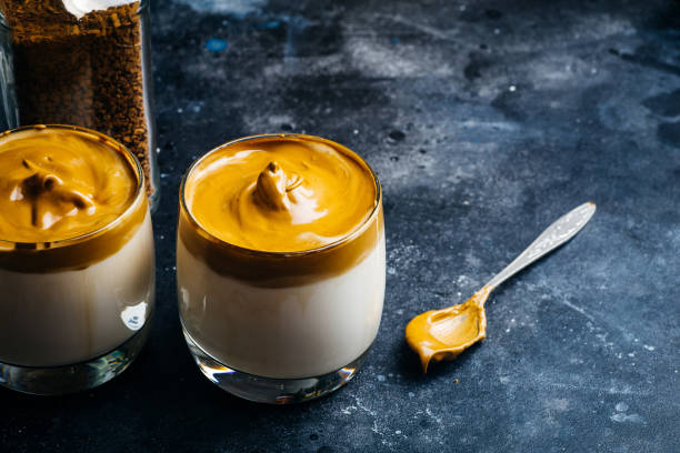 istock Dalgona coffee drink background. Korean coffee drink made with whipped instant coffee, sugar and milk. 1250271147