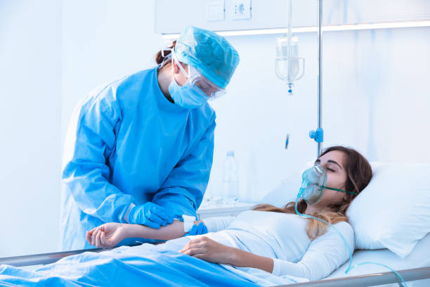 istock Nurse checking a drip on an ill patient 1250271206