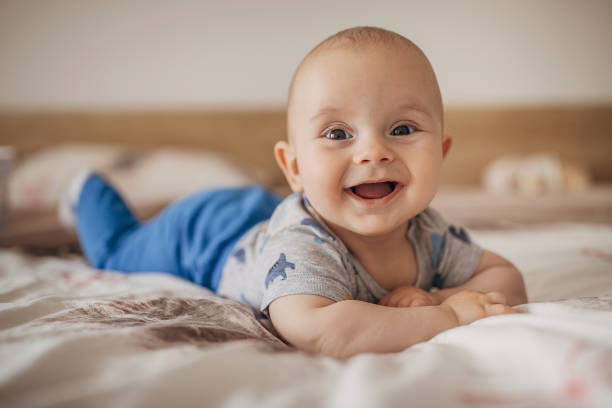 istock Beautiful baby boy lying on bed and smiling 1250272206
