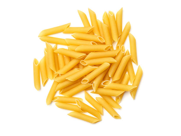 Pasta isolated on white background. Top view Penne Rigate pasta isolated on white background. Top view carbohydrate food type photos stock pictures, royalty-free photos & images