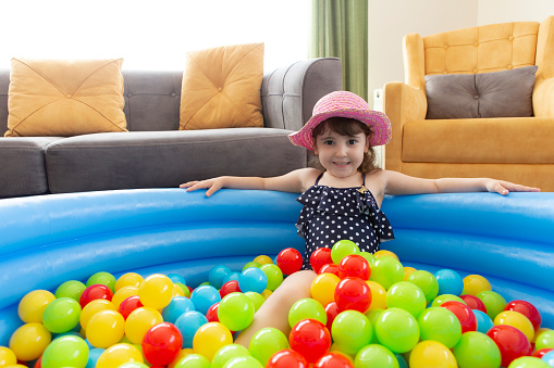 little girl playing in the ocean ball pool