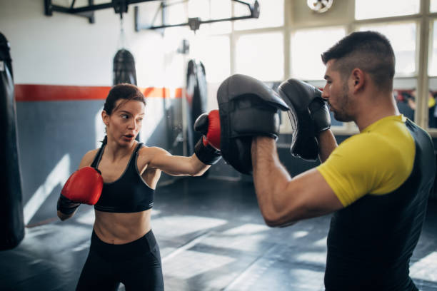 istock Fit woman kickboxer sparring with her coach 1250274622