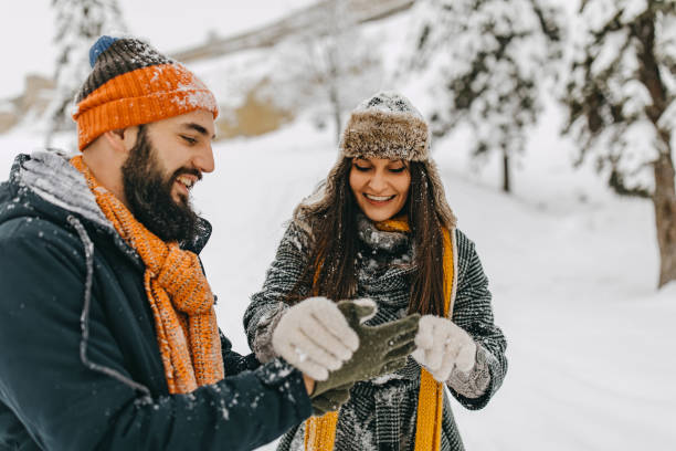 istock Couple in the snow playing 1250274991