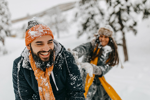 Couple in the snow playing