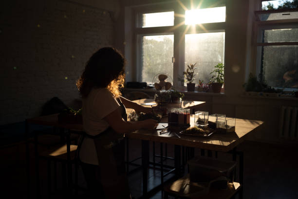 istock Girl Making Florarium in sunlight 1250275037
