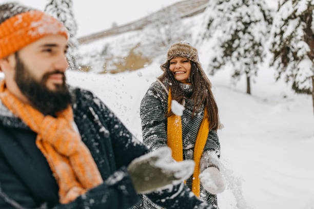 istock Couple in the snow playing 1250275085