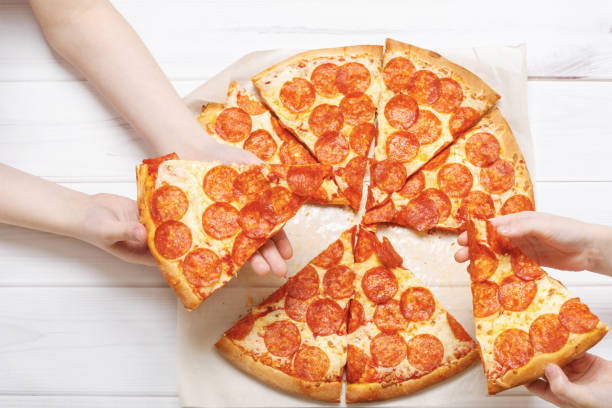 istock Family eating peperoni pizza. 1250275978