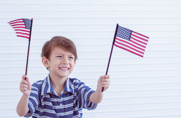 istock A little boy holding american flags 1250277889