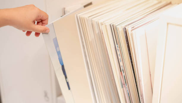 istock Female hand picking the  CD player for play with the CD machine, 1250282113