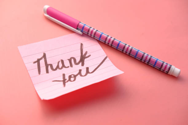 istock pink sticky note with thank you on pink desk 1250284995