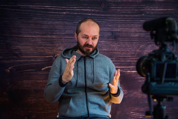 istock Man in studio vlogging in front of camera 1250286795