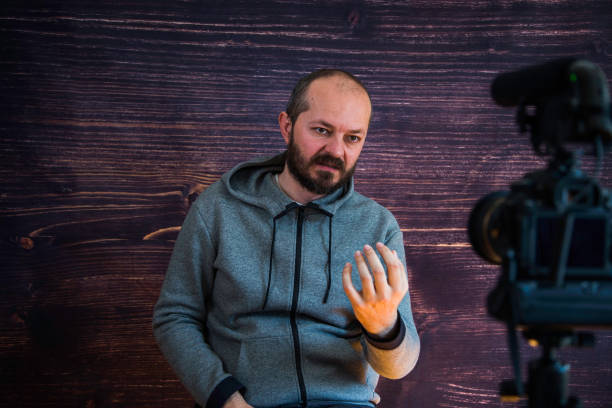 Man in studio vlogging in front of camera
