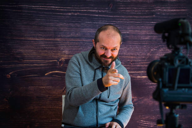 istock Man in studio vlogging in front of camera 1250286955