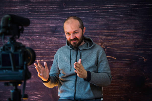 istock Man in studio vlogging in front of camera 1250286961