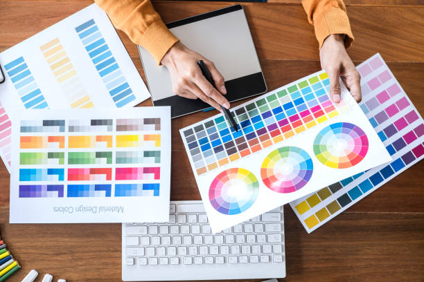 istock Image of female creative graphic designer working on color selection and drawing on graphics tablet at workplace with work tools and accessories, top view workspace 1250288822