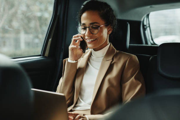 istock Businesswoman working inside a cab on the way to work 1250292164