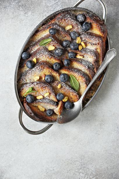 istock Bread pudding with vanilla sauce, blueberry and lavender flowers. 1250292947