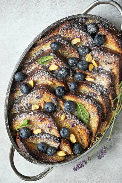 istock Bread pudding with vanilla sauce, blueberry and lavender flowers. 1250293002