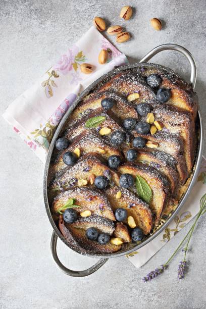 istock Bread pudding with vanilla sauce, blueberry and lavender flowers. 1250293007