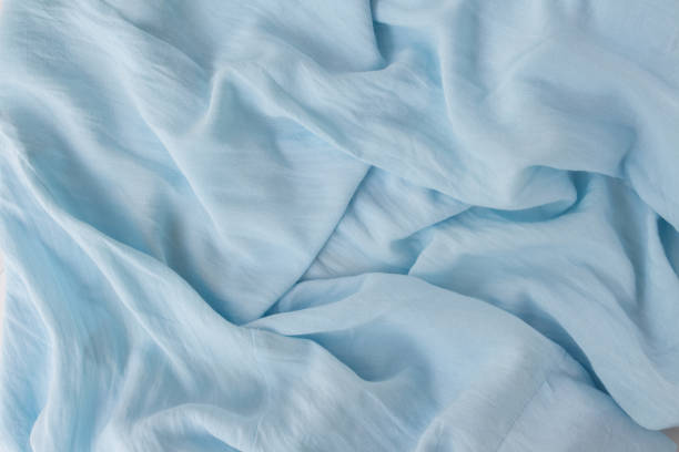 istock Flat lay modern abstract background blue fabric. Natural blue texture in beautiful folds. Blogger concept, Top view 1250293510