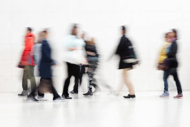 istock Blurred People Walking on White Hallway 1250297360